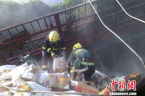 8月1日6時(shí)左右，滬昆高速上饒段一貨車側(cè)翻著火，駕駛室燒成空殼。圖為消防官兵清理現(xiàn)場。吳兵章 攝